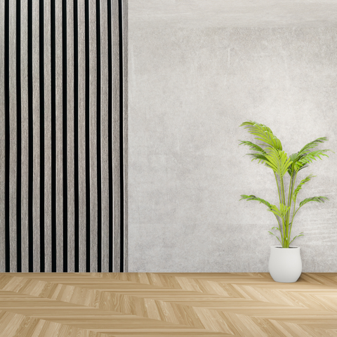 Grey acoustic wall panel in plain room with patterned floor and potted plant 